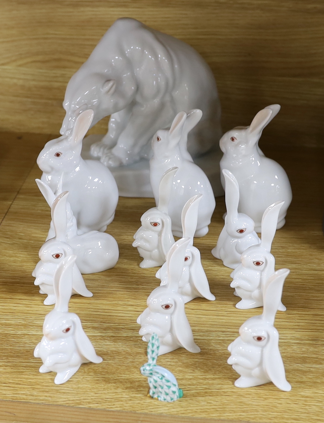 An Herend Polar bear and three sets of four graduated white glazed rabbits and a single green glazed rabbit, all by Herend Polar bear, 20cm high (14)